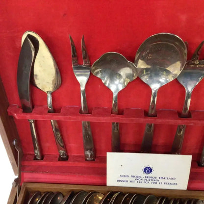Set of silver cutlery in a red case with a label