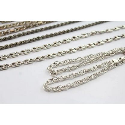 Silver chains of different styles on a white background