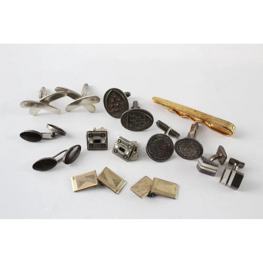 Collection of various cufflinks and a tie clip