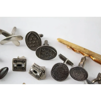 Collection of vintage-style cufflinks on a white background