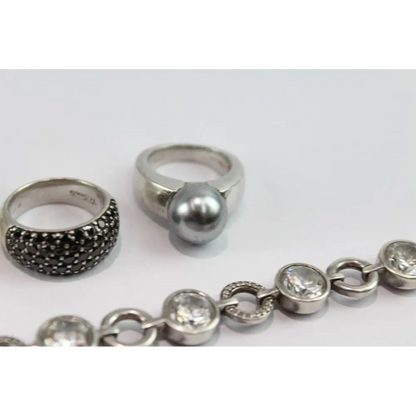 Silver rings and bracelet on a white background