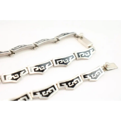 Silver bracelet with black geometric patterns 
