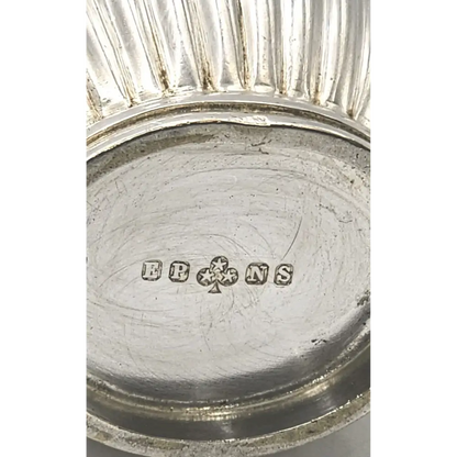 Close-up of a silver object with 'EBONS' branding 