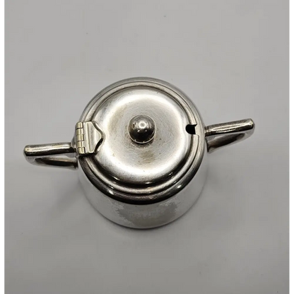 Silver teapot on a gray background