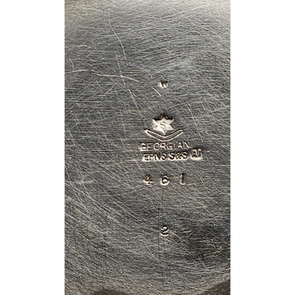 Close-up of a silver object with 'Georg Jensen' branding