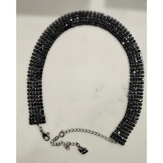 Black beaded necklace on a white background