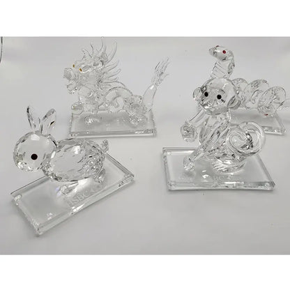 Set of three clear crystal animal figurines on a white background