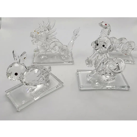 Set of three clear crystal animal figurines on a white background