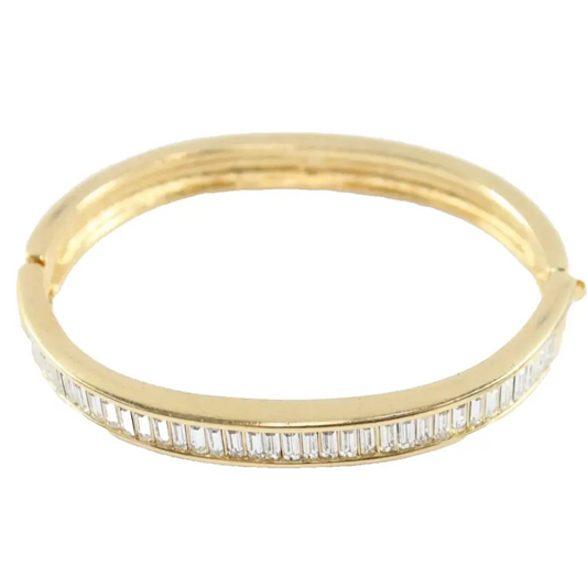 Gold bracelet with diamond accents on a white background