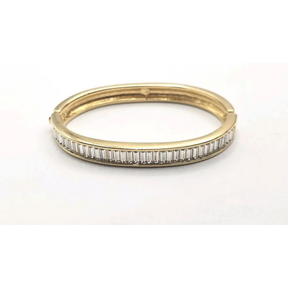 Gold Bangle with diamond accents on a white background
