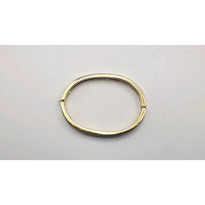 Gold Bangle on a light gray background
