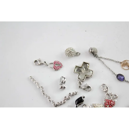 Collection of various jewelry charms on a light gray background