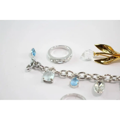 Silver bracelet with gemstone charms on a white background