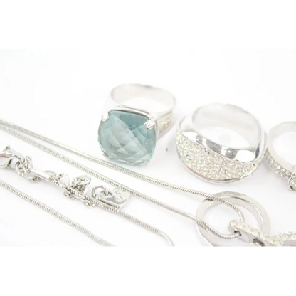 Silver jewelry set with a pendant and chain on a white background