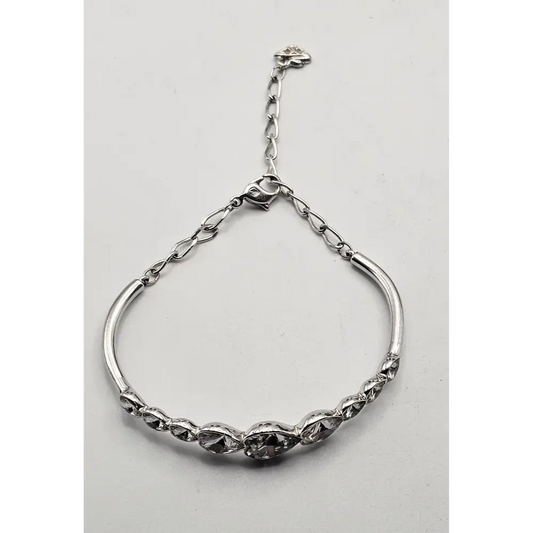 Silver bracelet on a light gray background