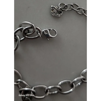 Silver chain bracelet on a gray background