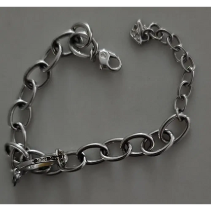 Silver chain bracelet on a gray background