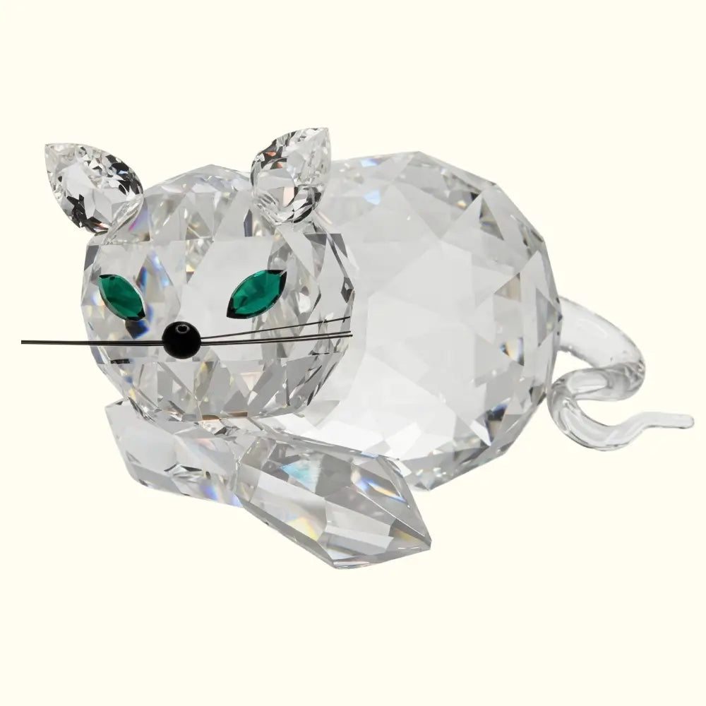 Crystal mouse figurine with green eyes on a white background