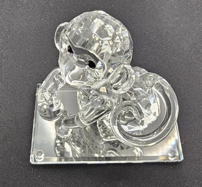 Crystal monkey figurine on a dark background