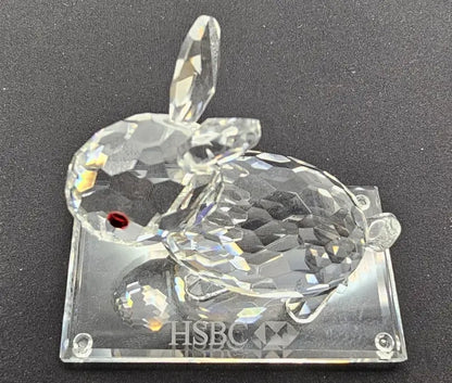 Crystal rabbit figurine with 'HSBC' branding on a black background
