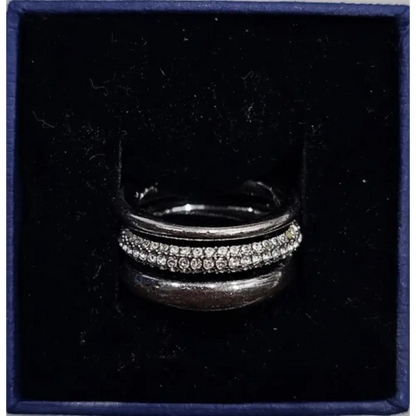 Silver ring with gemstones in a dark blue box