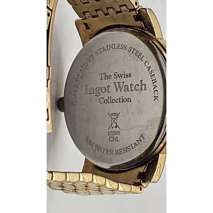 Back view of a gold watch with 'The Swiss Ingot Watch Collection' engraving