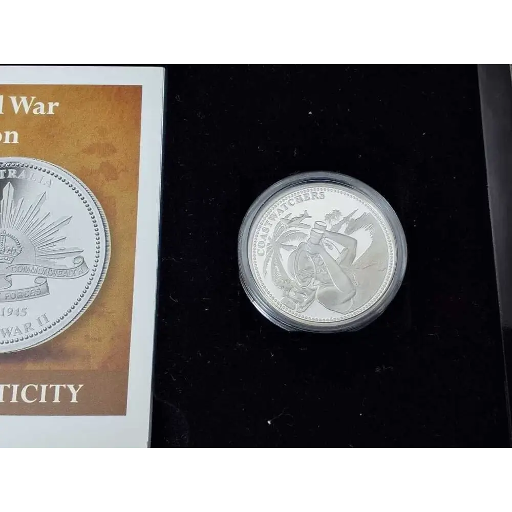 Silver coin with a decorative design on a black background