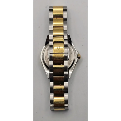 Two-tone watch with gold and silver band on a gray background