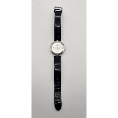 Wristwatch with black strap on a light gray background