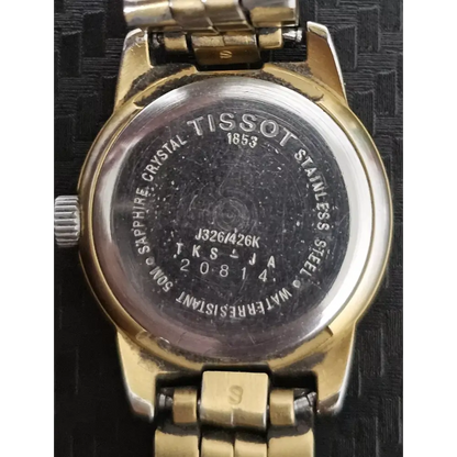 Back view of a Tissot watch with visible branding and model number.