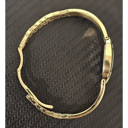 Gold watch on a textured black background