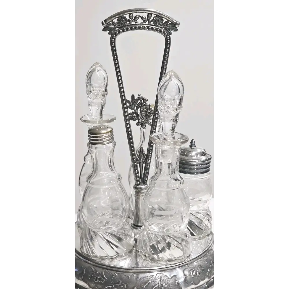 Set of glass bottles with silver metal stands on a white background