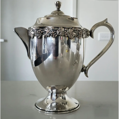 Side view of vintage 5-piece silver plated tea set showing teapot and sugar bowl