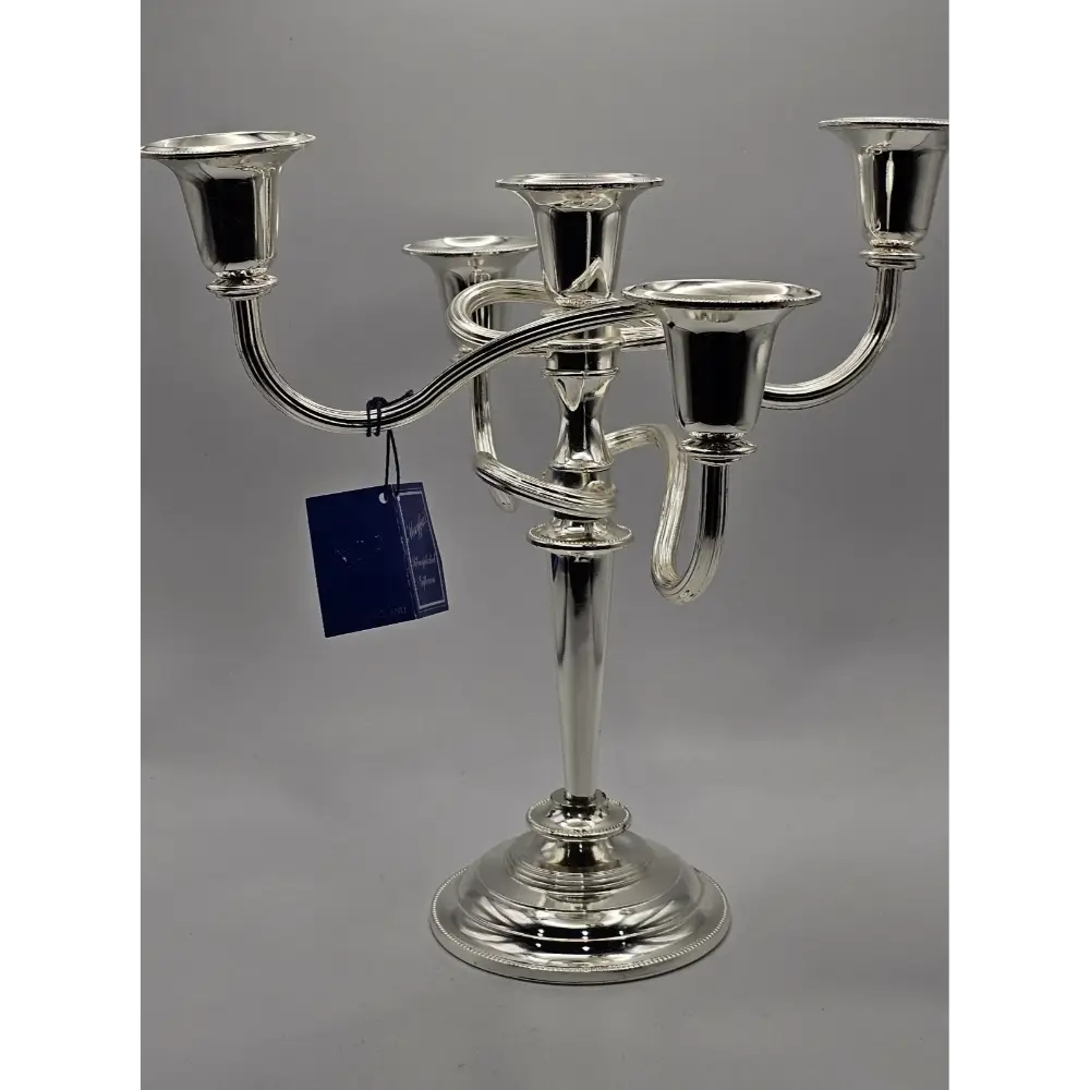 Silver candelabra with a tag on a gray background