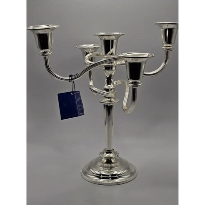 Silver candelabra with a tag on a gray background