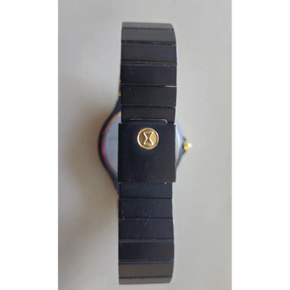 Black wristwatch with a gold emblem 