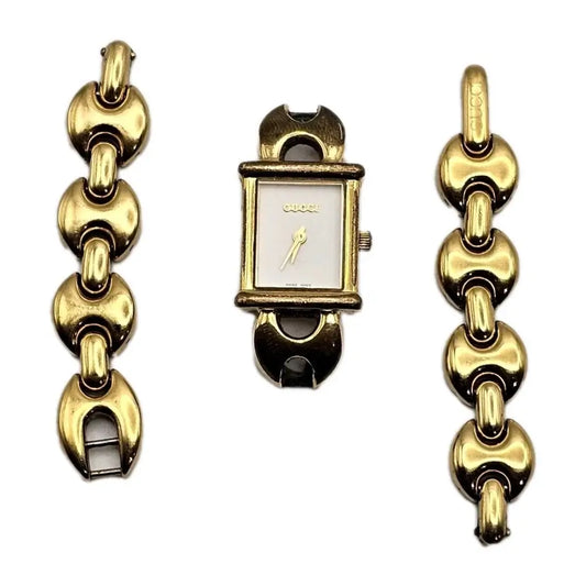 Gold chain bracelet with a small square watch face