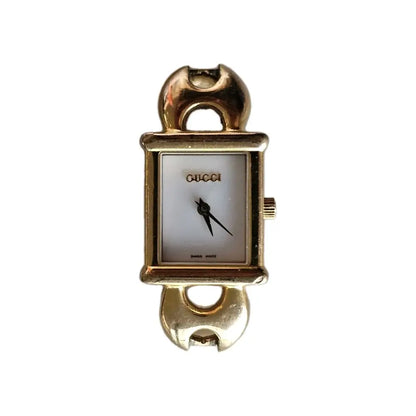 Gold Gucci watch on a white background