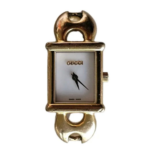 Gold Gucci watch on a white background