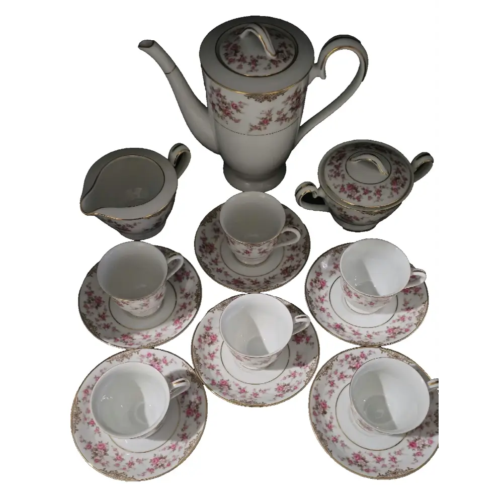 Full arrangement of cups, saucers, creamer, sugar bowl, and teapot