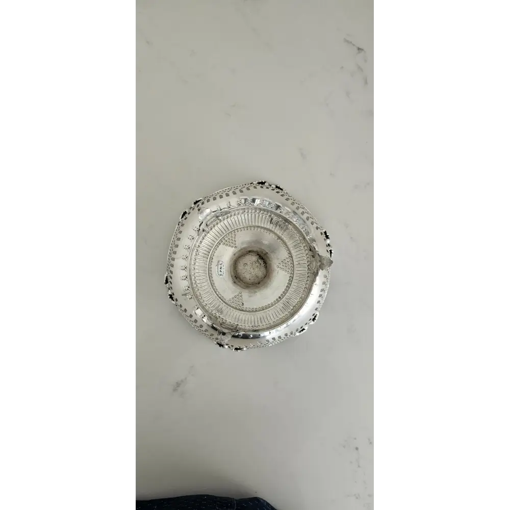 Decorative silver platter on a marble surface