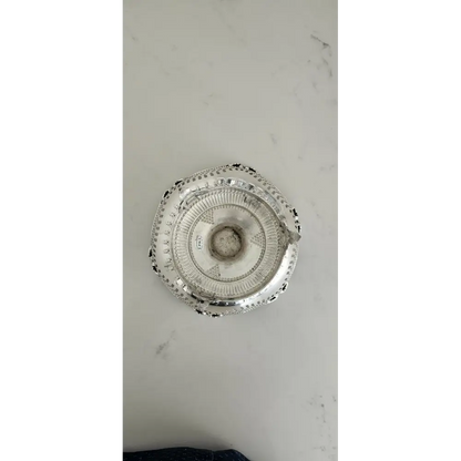Decorative silver platter on a marble surface