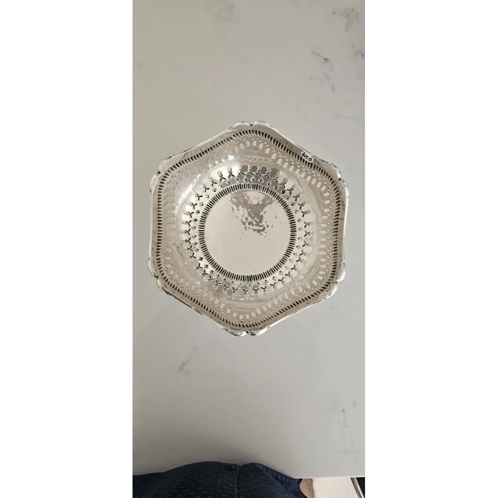 Decorative silver platter on a light gray background