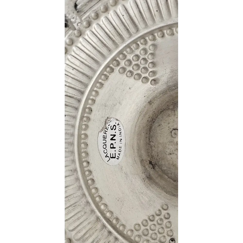 Close-up of the intricate pierced patterns and scalloped edges of the silver-plated dish.