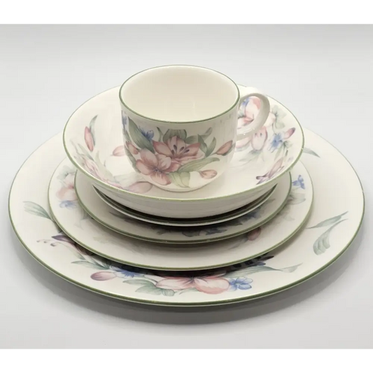 Set of floral ceramic dinnerware on a white background
