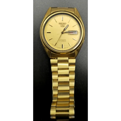 Gold Seiko watch on a dark background