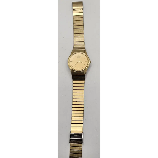 Gold wristwatch with a metal band