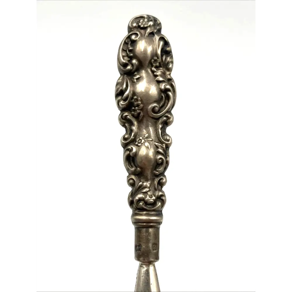 Decorative silver spoon handle on a white background