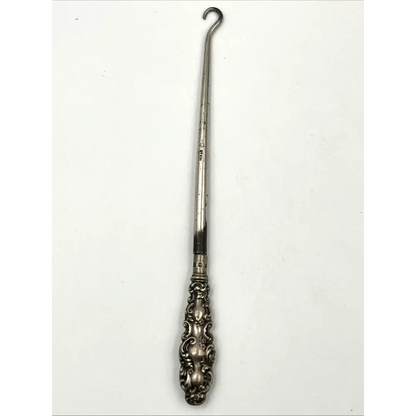 Detailed craftsmanship of 1900 sterling silver shoehorn and button hook