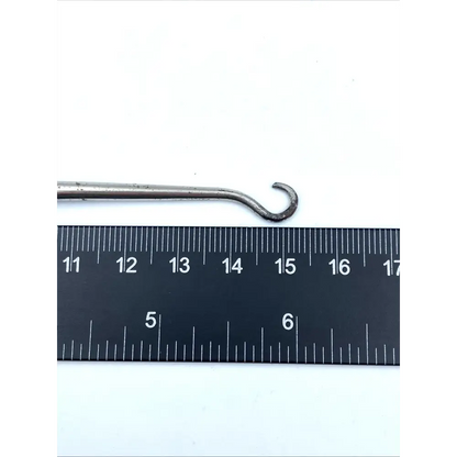 Metal hook next to a ruler